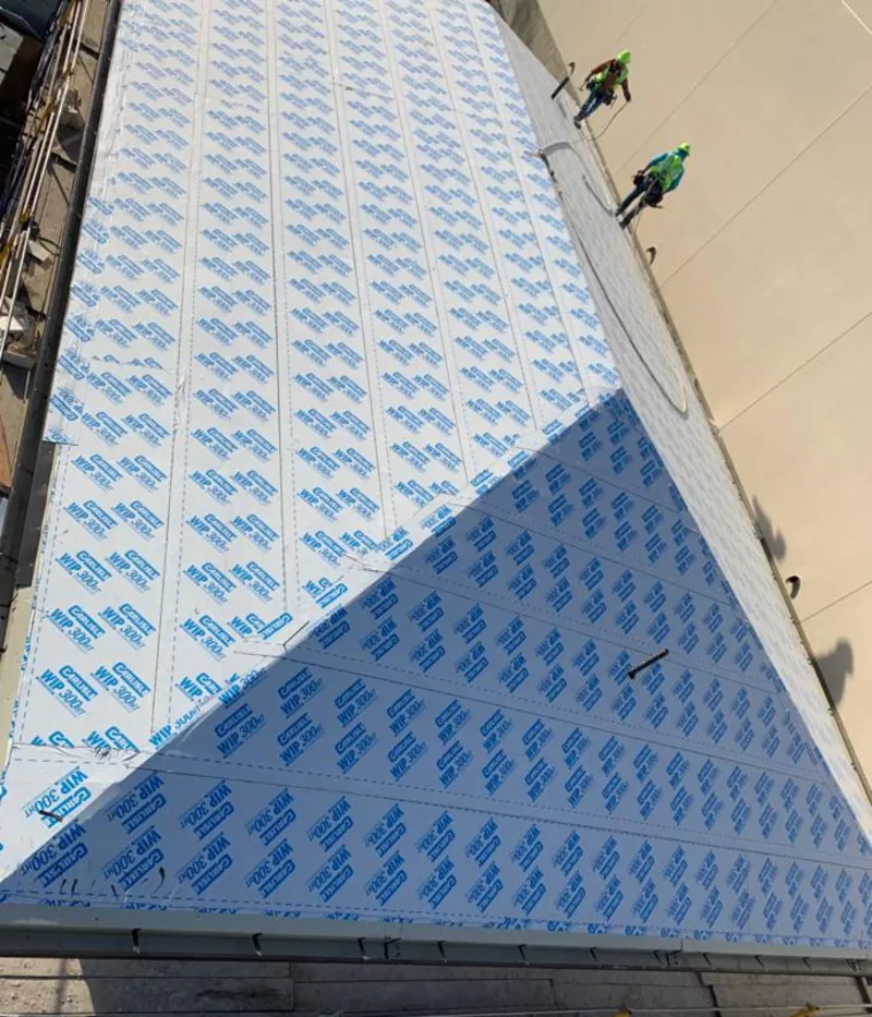 Professional roofers installing underlayment on a metal roof in Carbondale